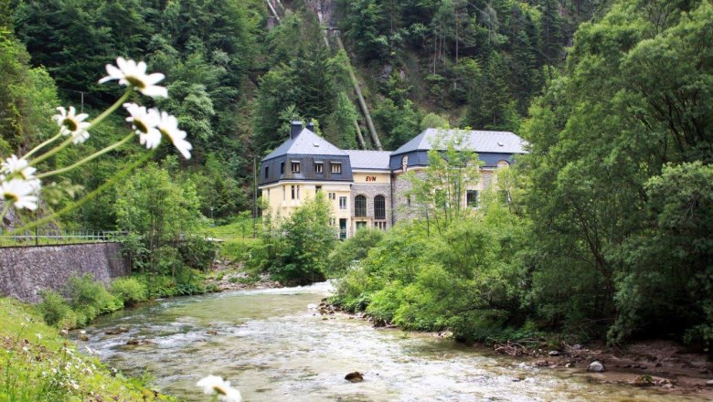 EVN-Kraftwerk Wienerbruck in grüner Landschaft mit Fluss.